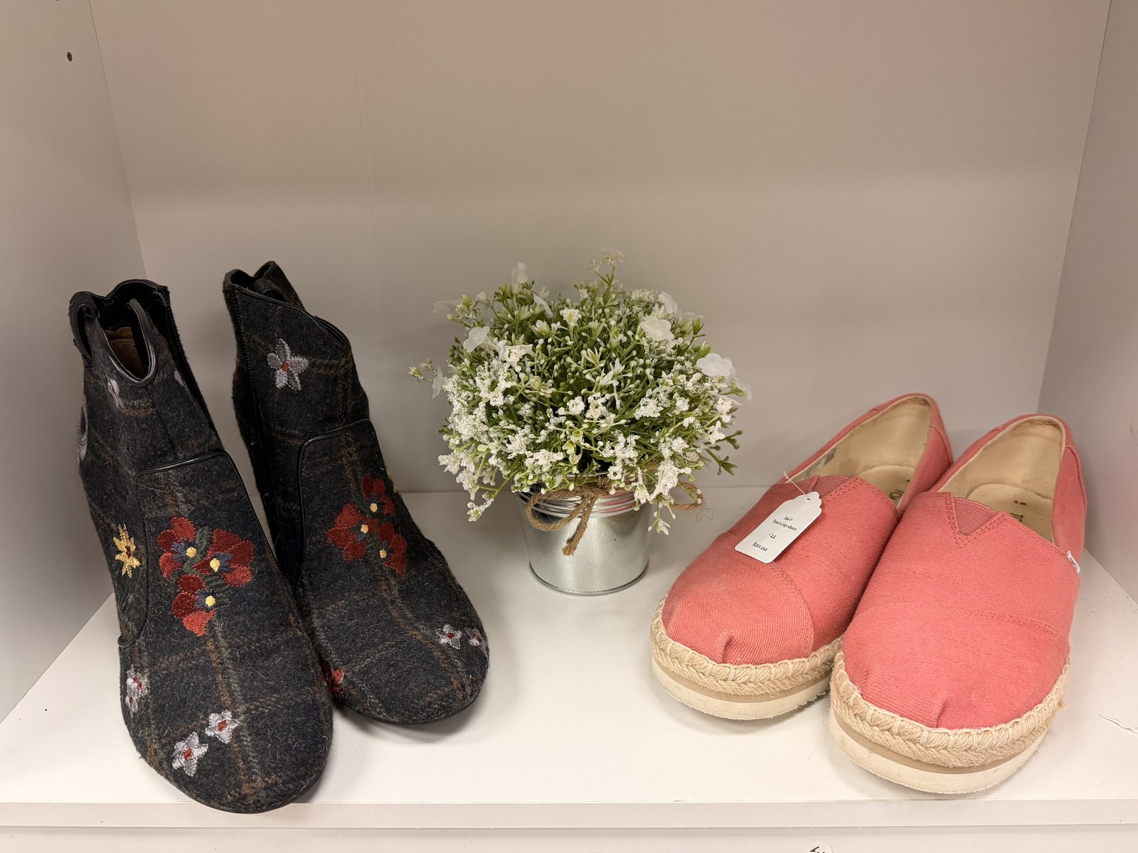 Embroidered boots, baby's-breath, and blush espadrilles tucked into a Soco Chic shelf