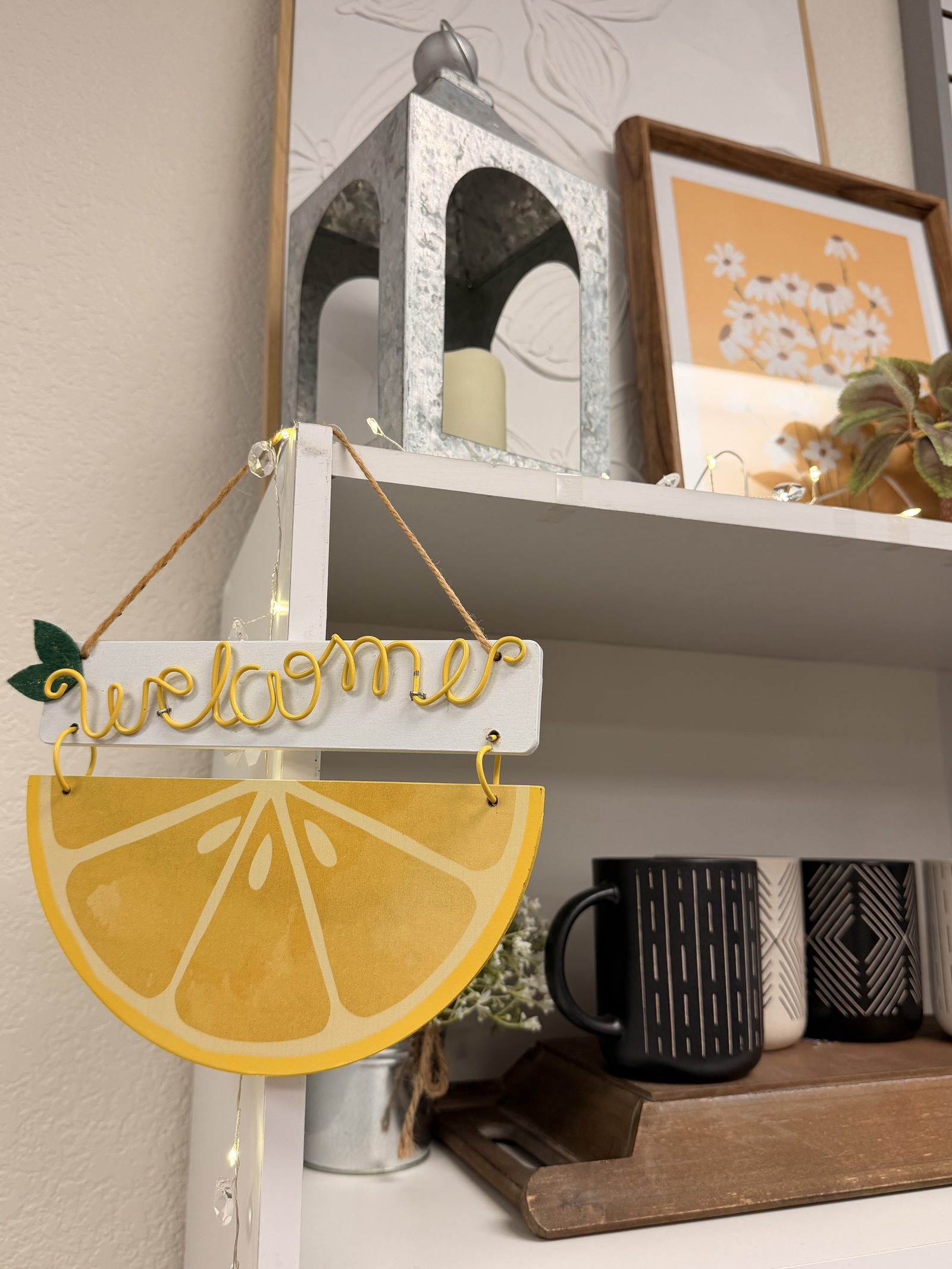 A small "welcome" lemon sign hung in front of the boutique shelves